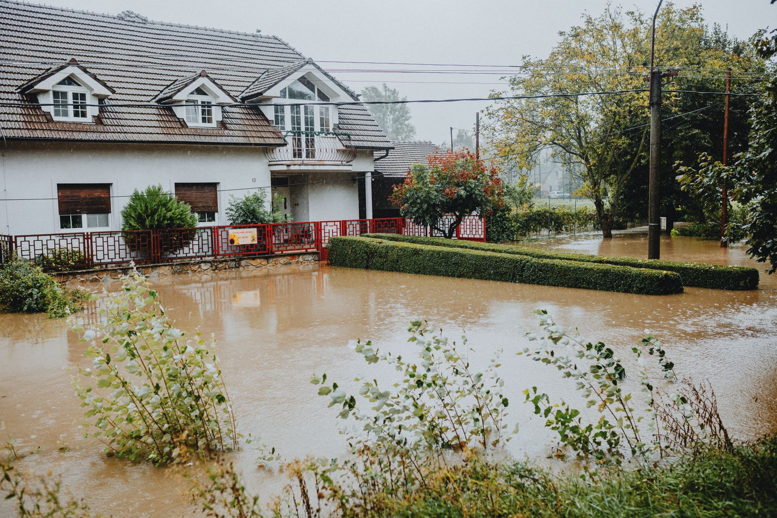 Home surrounded by floodwater, water damage insurance claim